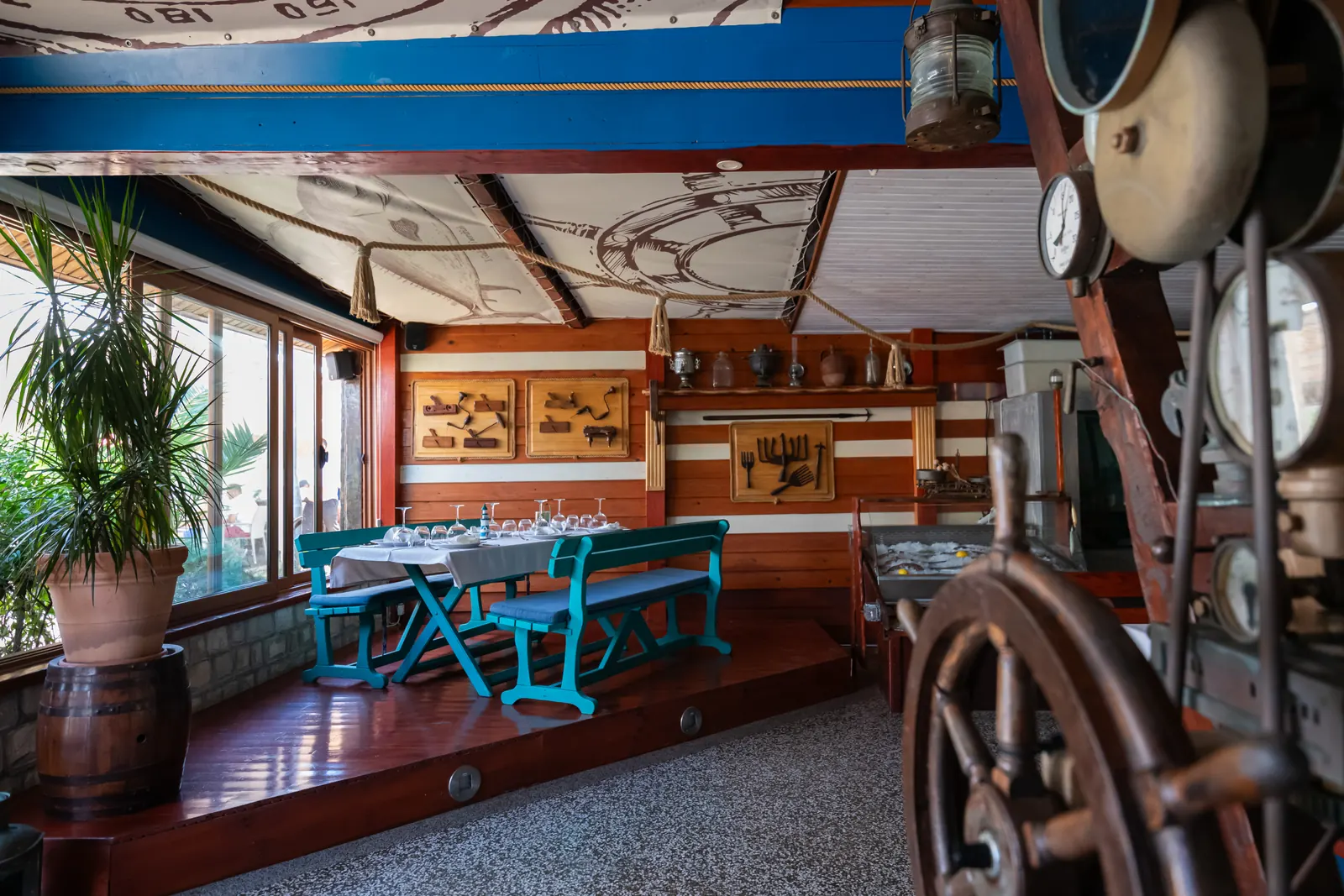 Ship wheel and the turquoise dining corner
