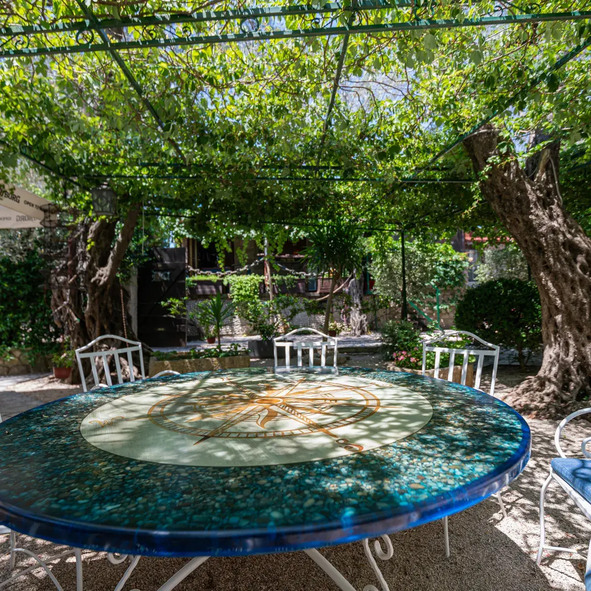 Blue mosaic table in the garden under the vine