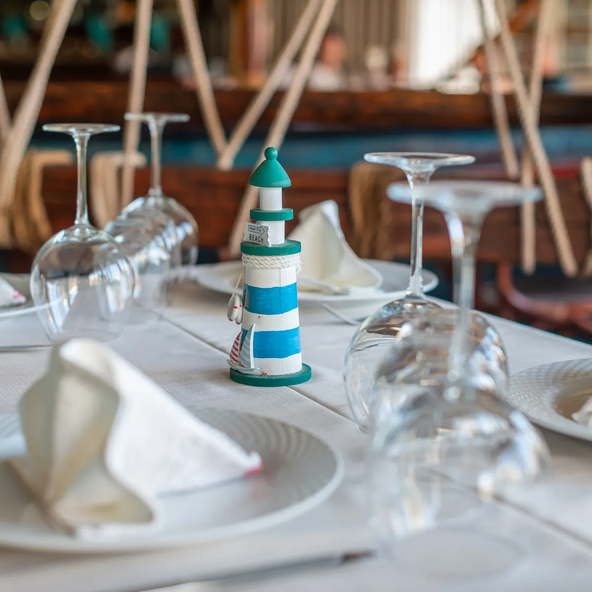 Table setting detail with a lighthouse figurine