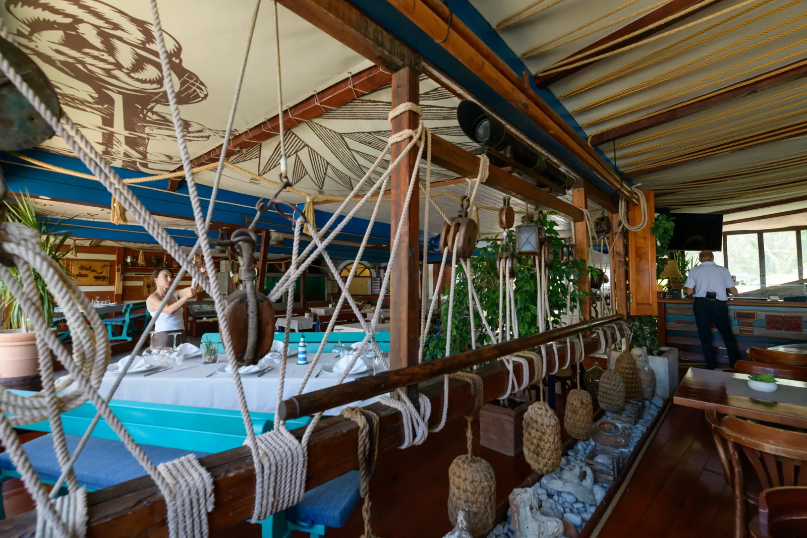 A table set inside the boat with ship ropes