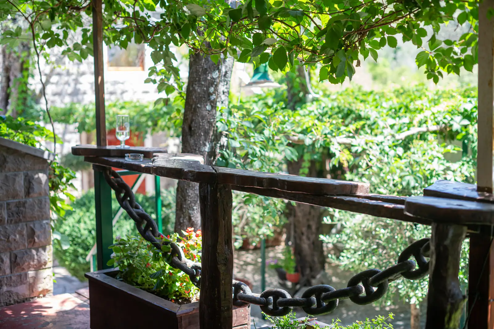The porch with the chain and garden flowers